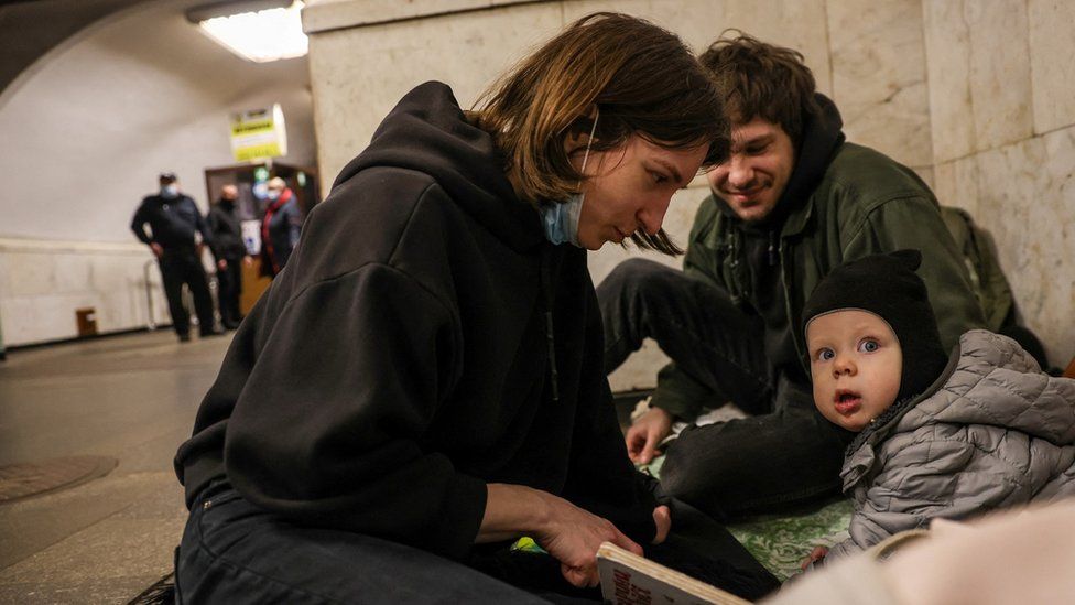 People gather at a metro station as they seek shelter from expected Russian air strikes, in Kyiv